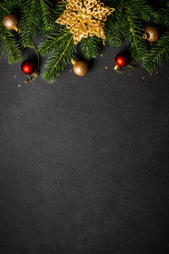 Christmas flat lay background with holiday decorations. Vertical format. Flat lay image on black with copy space.