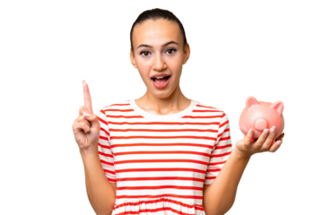 Young Arab woman holding a piggybank over isolated background pointing up a great idea