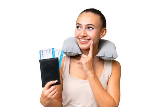 Young Arab woman with Inflatable Travel Pillow over isolated background thinking an idea while looking up