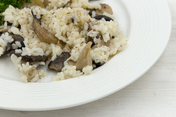 Plate of mushroom risotto, garnished with Oyster mushrooms Pleurotus ostreatus .