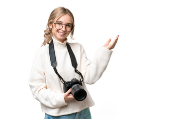 Young photographer English woman over isolated background extending hands to the side for inviting...