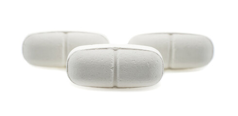 Medical pills with shadow on a white background close-up. Treatment. Medical preparations