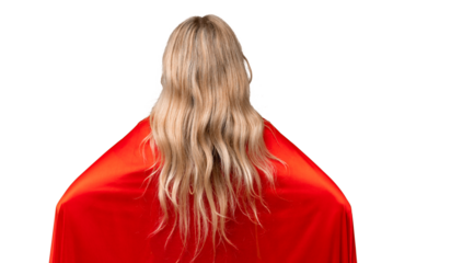 Young English woman over isolated background in superhero costume in back position