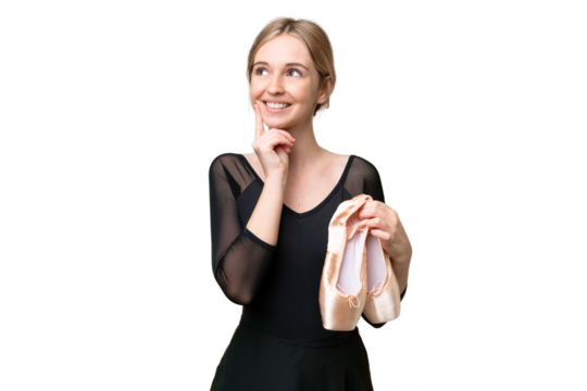 Young English woman practicing ballet over isolated background thinking an idea while looking up
