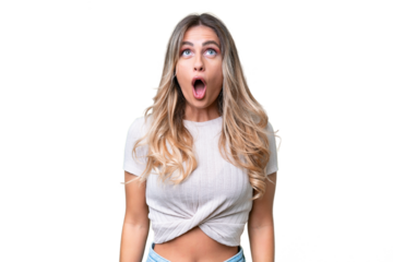 Young Uruguayan woman over isolated background looking up and with surprised expression