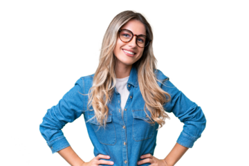Young Uruguayan woman over isolated background posing with arms at hip and smiling