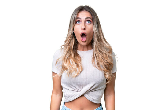 Young Uruguayan woman over isolated background looking up and with surprised expression