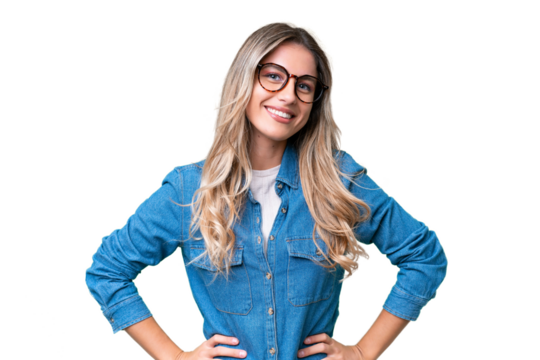 Young Uruguayan woman over isolated background posing with arms at hip and smiling