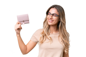 Young Uruguayan woman holding a wallet over isolated background with happy expression