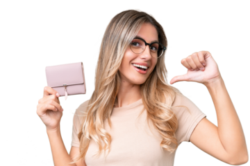 Young Uruguayan woman holding a wallet over isolated background proud and self-satisfied