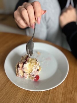 person holding a plate with cake