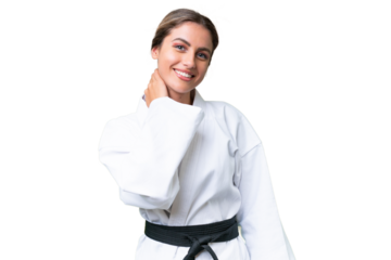 Young Uruguayan woman doing karate over isolated background laughing
