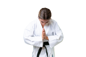 Young Uruguayan woman over isolated background doing karate and saluting