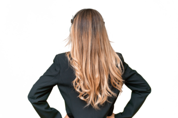 Telemarketer pretty Uruguayan woman working with a headset over isolated background in back position