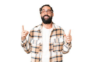 Naklejka premium Young man with beard over isolated chroma key background pointing up a great idea