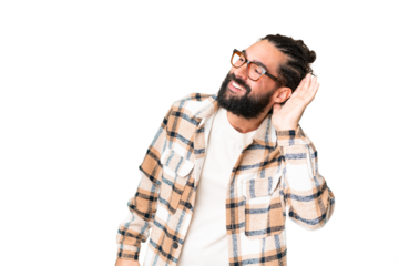 Young man with beard over isolated chroma key background listening to something by putting hand on the ear