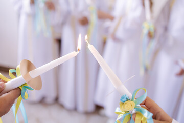 Nuns help children lights candles. Sisters ministers in the church