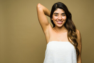 Attractive latin woman showing her smooth armpits after shaving or depilation