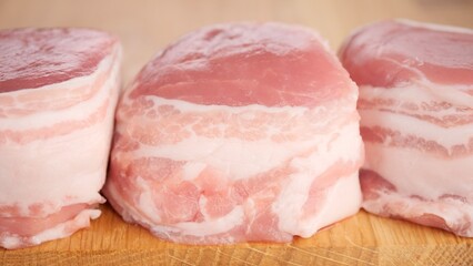 Raw Pork fillet Medallions on wooden board