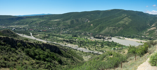 Fototapeta na wymiar Large panoramic view of the Kura (Mtkvari) river and some villages. Georgia
