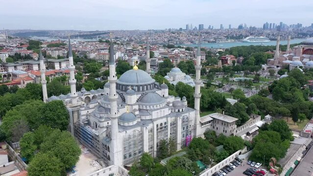 Slow circling aerial view around the Sultan Ahmed blue Mosque in Istanbul, Turkey, during a cloudy day