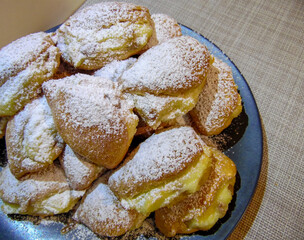 Sochniki, cottage cheese cookies on a gray dish against a background of coarse fabric