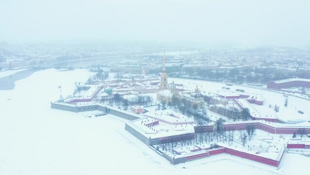 Aerial view wide shot of Peter and Paul fortress Saint Petersburg, winter season during snowfall. Snow covered white cityscape