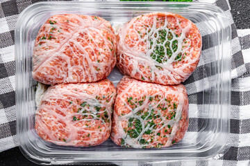 meat cutlet in fat grid fatty mesh pork, beef raw minced meat and spice fresh snack meal food snack on the table copy space food background rustic top view