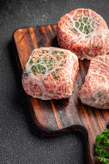 meat cutlet in fat grid fatty mesh pork, beef raw minced meat and spice fresh snack meal food snack on the table copy space food background rustic top view