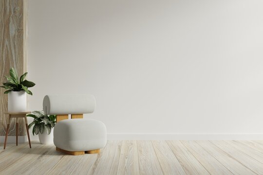 Modern minimalist interior with a gray armchair on empty white wall background.