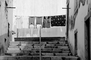 Narrow street with stairs and clothesline in Alcacer do Sal town