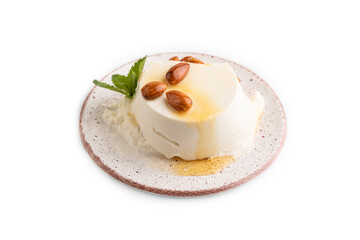 Ricotta cheese with honey and almonds isolated on white. side view, close up.