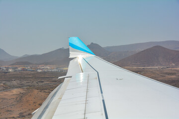 View from the plane window during the landing approach over the island of Tenerife to Reina Sofía...