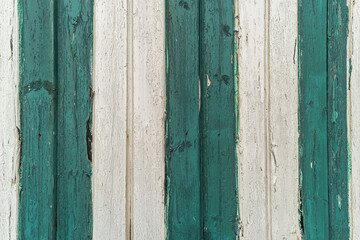 The background of weathered white and green stripes painted wood