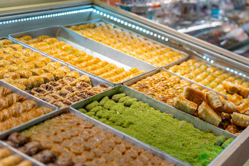 Traditional Turkish dessert baklawa in different flavors and styles in the Egyptian bazaar in Istanbul. Dessert shop at grand bazar baklava ramadan
