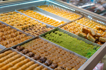Traditional Turkish dessert baklawa in different flavors and styles in the Egyptian bazaar in Istanbul. Dessert shop at grand bazar baklava ramadan