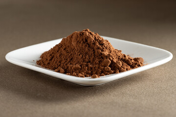Cacao. Pile of cocoa powder in plate