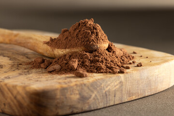 Cocoa powder in wooden spoon