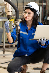 Industrial engineer woman working on robot arm maintenance in modern technology factory. Technician...