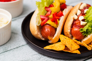 Hot dogs with different toppings on a table