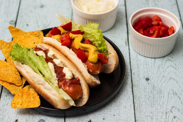 Hot dogs with different toppings on a table