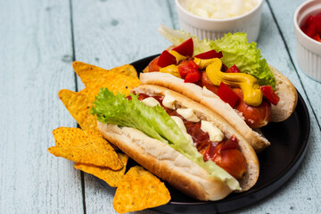 Hot dogs with different toppings on a table