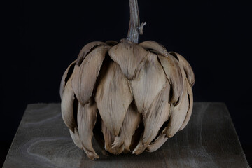 Dried artichoke isolated on black background