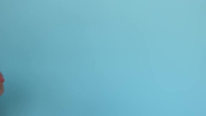 A woman's hand with a hematoma on a blue background. A signal for help is a gesture that can help people experiencing domestic violence.