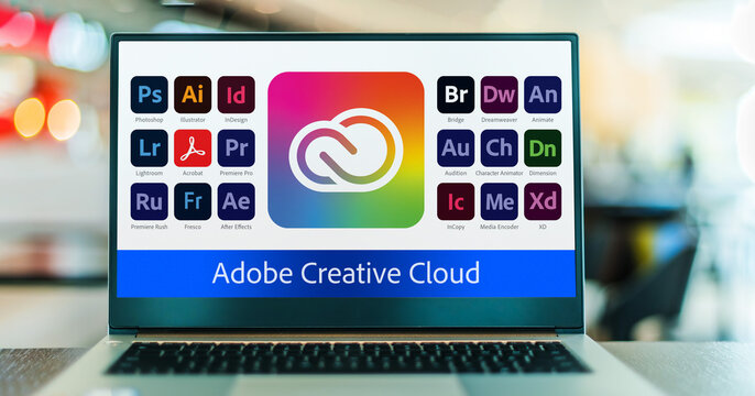 Laptop computer displaying logotypes of Adobe Creative Cloud