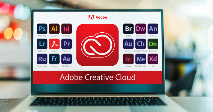 Laptop computer displaying logotypes of Adobe Creative Cloud