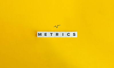 Metrics Banner, Icon, and Word on Block Letter Tiles on Yellow Background. Minimal Aesthetics.