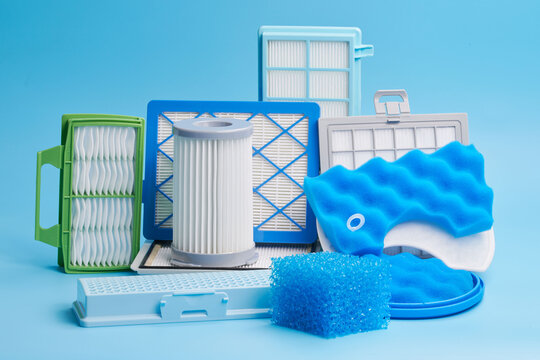 New clean dust air filters for vacuum cleaner isolated on blue background