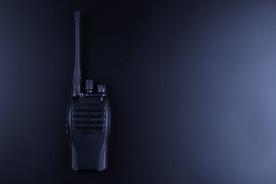 Black rectangle portable device with antenna isolated on black background. radio transceiver set for communication. radio set, walkie-talkie
