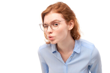 Fototapeta premium Redhead young woman wearing glasses squinting while looking at camera isolated on white background. Vision problems concept
